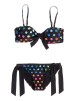 Bikini negro con topos de colores de Roxy (65 euros)
