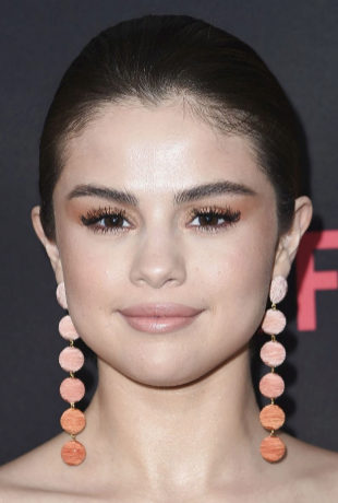 Selena Gomez con maquillaje de ojos naranja.