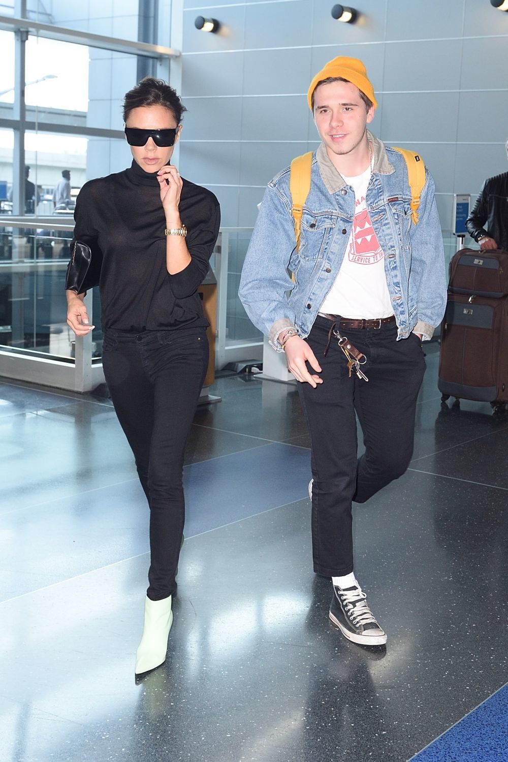 Victoria Beckham en el aeropuerto con su hijo Brooklyn.