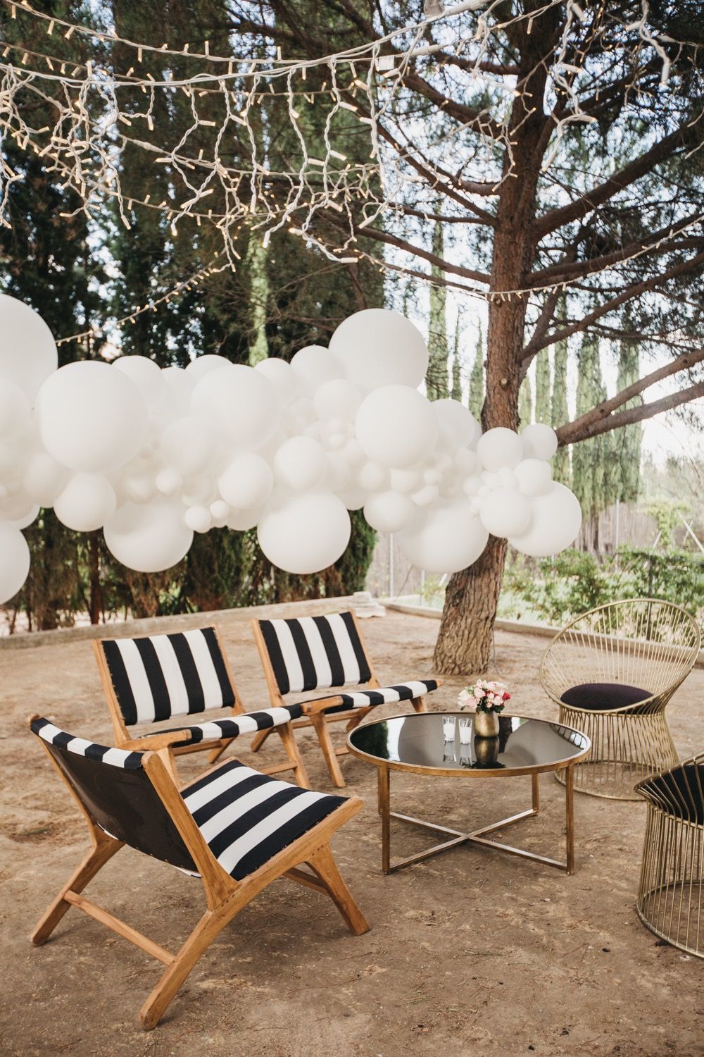 Una nube blanca de globos de que parecía flotar entre los árboles, creada por GlobosPimPamPum, formaba parte de la decoración de las zonas lounge, sencillas pero rompedoras y marcadas por los tonos de la fiesta, se convirtió en un inesperado photocall al caer la noche.