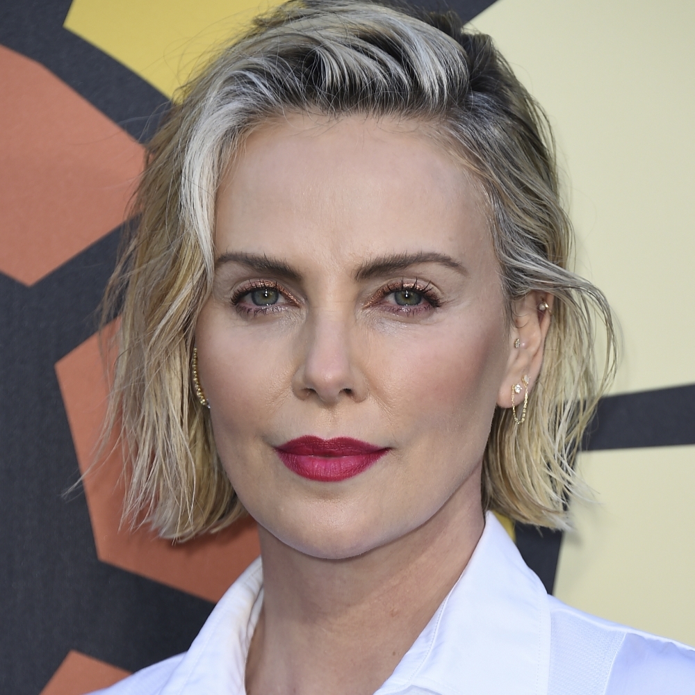 Charlize Theron with a medium hair with a wet effect and soft waves.