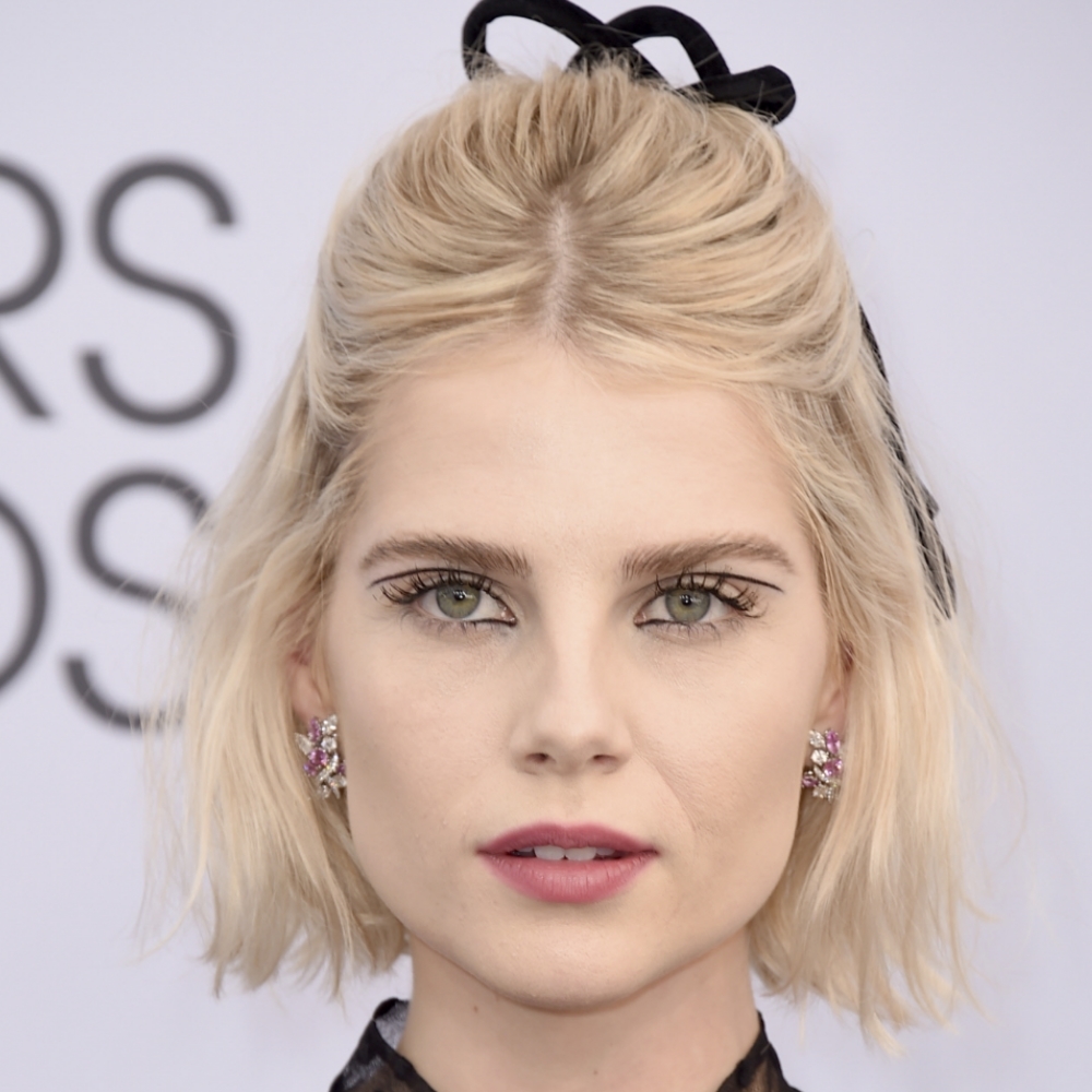 Lucy Boynton and her semi-updo with a bow.