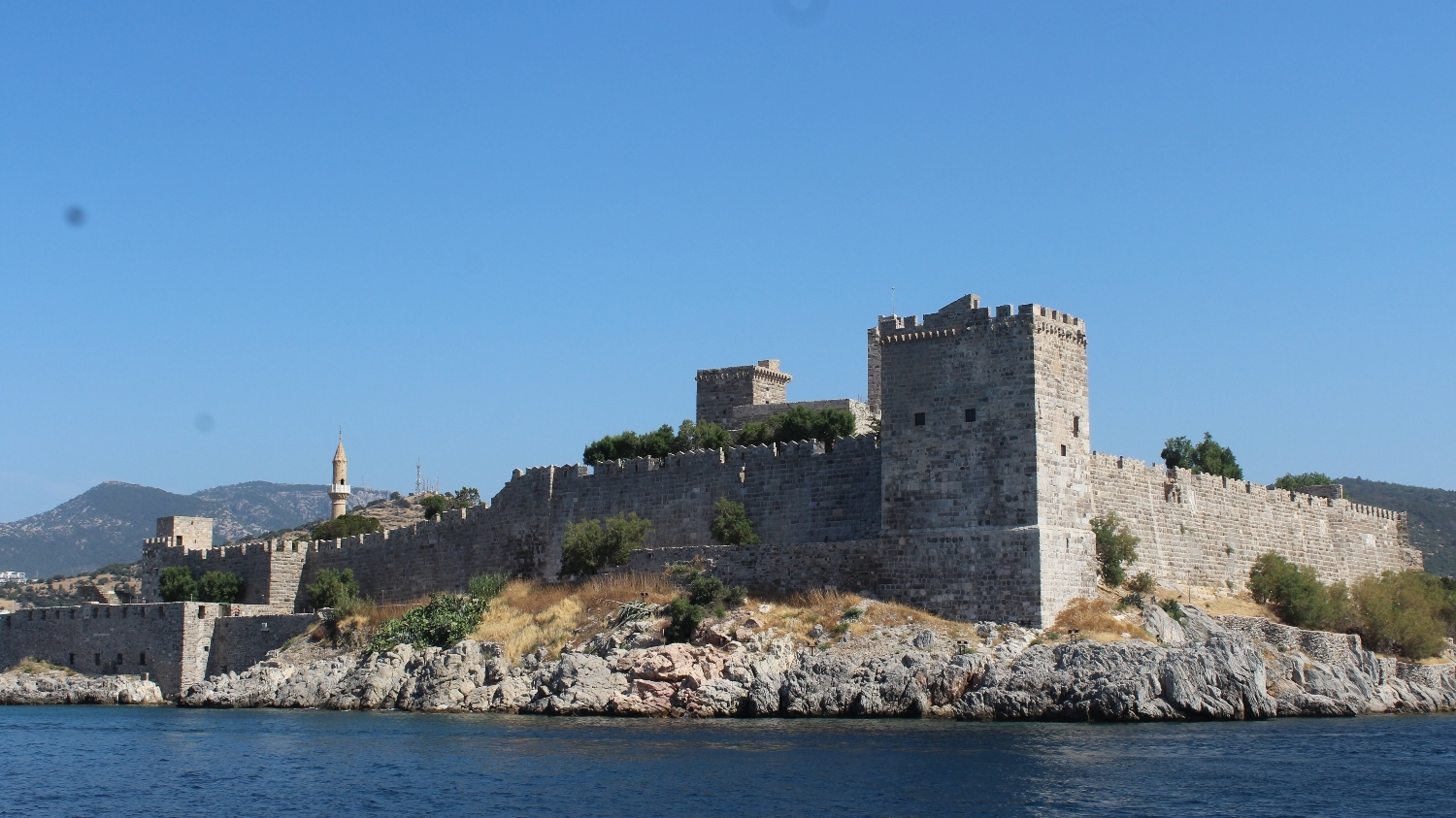 The Castle of San Pedro de Halicarnassus of Bodrum bordered from the schooner.