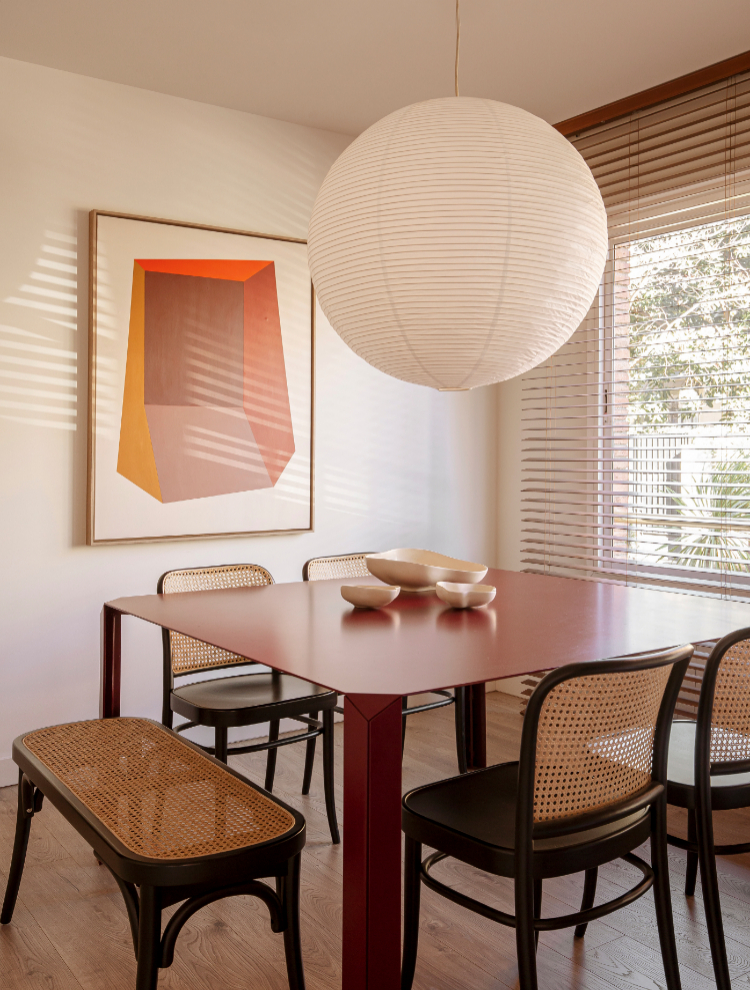 En la zona de comedor, mesa diseñada por Espacio en Blanco, sillas Ton y lámpara Rice Paper de Hay