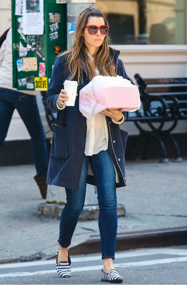 Jessica Biel with blue parka jacket, capri jeans, cream blouse and striped slippers