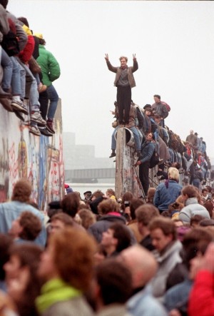 Un joven subido sobre del muro de Berln el dia de su caida.